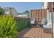 Cozy outdoor deck with seating area for relaxation and privacy, featuring greenery and lighting at 833 Society Ct, Woodstock, GA 30188