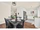 An eat-in dining area with a table for six is adjacent to the bright kitchen and features hardwood floors at 833 Society Ct, Woodstock, GA 30188