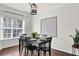 Elegant dining room with a black dining table and chairs, under a stylish hanging light fixture at 833 Society Ct, Woodstock, GA 30188