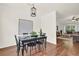 Dining room with hardwood flooring, stylish chandelier, and natural light, adjacent to the living room at 833 Society Ct, Woodstock, GA 30188