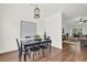 Cozy dining area with black table and chairs, featuring hardwood floors and modern decor at 833 Society Ct, Woodstock, GA 30188