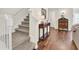 Inviting entryway with staircase, hardwood floors, and decorative table and lamp at 833 Society Ct, Woodstock, GA 30188