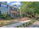 Charming townhomes with brick accents, manicured lawns, and welcoming front entrances at 833 Society Ct, Woodstock, GA 30188