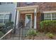 Inviting front entrance with a charming porch, brick facade and manicured shrubbery at 833 Society Ct, Woodstock, GA 30188