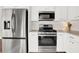 A modern, efficient kitchen with stainless steel appliances and white cabinetry at 833 Society Ct, Woodstock, GA 30188