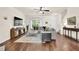 Bright living room featuring hardwood floors, a comfortable sectional sofa, and large windows at 833 Society Ct, Woodstock, GA 30188