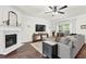 Bright living room with a fireplace, flat screen, hardwood floors and large sectional at 833 Society Ct, Woodstock, GA 30188