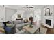 Inviting living room with a cozy fireplace, plush sectional sofa and hardwood flooring at 833 Society Ct, Woodstock, GA 30188