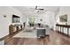 Bright living room with hardwood floors, neutral tones, and modern furnishings, with a large sectional sofa at 833 Society Ct, Woodstock, GA 30188