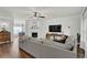 Spacious open-concept living room with hardwood floors, flat screen, and a glimpse into dining area at 833 Society Ct, Woodstock, GA 30188