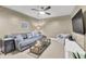 Comfortable media room with large sectional sofa, TV, and plenty of natural light at 833 Society Ct, Woodstock, GA 30188
