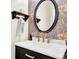 Charming powder room with decorative wallpaper, elegant mirror, and marble countertop at 833 Society Ct, Woodstock, GA 30188