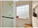 Modern shower with glass door, window, and tiled niche for storage of toiletries at 833 Society Ct, Woodstock, GA 30188