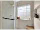 Spa-like shower with tiled walls, a glass enclosure, and a frosted window at 833 Society Ct, Woodstock, GA 30188