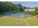 Community tennis courts surrounded by lush greenery at 833 Society Ct, Woodstock, GA 30188