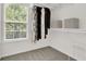 Well-lit walk-in closet with ample storage, shelving, and a window for natural light at 833 Society Ct, Woodstock, GA 30188