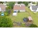 Aerial shot featuring home's backyard with pool, trampoline, storage building, and well-maintained lawn at 992 Harbins Pass Dr, Dacula, GA 30019