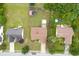 An aerial view shows home with mature trees, lawn, above ground pools, storage building, and shed at 992 Harbins Pass Dr, Dacula, GA 30019