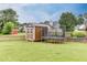 Spacious backyard with shed, trampoline, and well-maintained lawn at 992 Harbins Pass Dr, Dacula, GA 30019