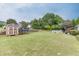 Lush backyard includes a storage building, trampoline, above ground pool, and garden area at 992 Harbins Pass Dr, Dacula, GA 30019