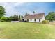 Expansive backyard showcases a pristine lawn, above ground pool, patio cover, and partial fence at 992 Harbins Pass Dr, Dacula, GA 30019