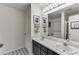Bright bathroom with double sinks, stylish flooring, and elegant fixtures at 992 Harbins Pass Dr, Dacula, GA 30019