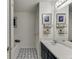 Bright bathroom with double sinks, stylish flooring, and elegant fixtures at 992 Harbins Pass Dr, Dacula, GA 30019