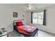 Bright bedroom with a large window, ceiling fan, and light hardwood floors at 992 Harbins Pass Dr, Dacula, GA 30019