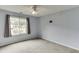 This light blue bedroom has gray carpet, curtains, and a white ceiling fan at 992 Harbins Pass Dr, Dacula, GA 30019