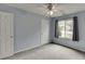 The bedroom offers natural light, a ceiling fan, and neutral-colored walls at 992 Harbins Pass Dr, Dacula, GA 30019