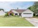 Charming single-story home with well-manicured lawn and landscaping at 992 Harbins Pass Dr, Dacula, GA 30019