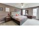 This primary bedroom offers natural light, dark walls, and comfortable decor at 992 Harbins Pass Dr, Dacula, GA 30019