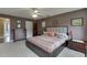 Cozy main bedroom with ceiling fan, an ensuite bathroom, and a large window for natural light at 992 Harbins Pass Dr, Dacula, GA 30019