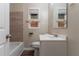 Clean bathroom with a tub, toilet, tiled accent wall and vanity with a mirror at 1421 Dennis Dr, Decatur, GA 30032