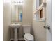 Functional bathroom featuring a pedestal sink, toilet, and a view from the window at 1421 Dennis Dr, Decatur, GA 30032
