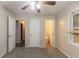 Cozy bedroom with carpet, ceiling fan, and convenient access to the bathroom at 1421 Dennis Dr, Decatur, GA 30032