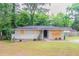 Charming single-story home with a covered front porch and a well-maintained lawn at 1421 Dennis Dr, Decatur, GA 30032