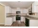 Bright kitchen featuring white cabinets and stainless steel appliances at 1421 Dennis Dr, Decatur, GA 30032