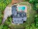 High aerial view of property with a pool, driveway and mature trees at 5588 Rhododendron Trl, Douglasville, GA 30135