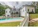 Spacious backyard with a swimming pool, patio, and manicured lawn at 5588 Rhododendron Trl, Douglasville, GA 30135