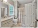 Bathroom featuring single vanity and shower with neutral colors at 5588 Rhododendron Trl, Douglasville, GA 30135