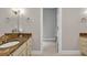 This bathroom features warm neutral walls, tile floors, and a granite counter with an open doorway to the shower at 5588 Rhododendron Trl, Douglasville, GA 30135