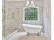 Bright bathroom with glass shower, soaking tub, and large window at 5588 Rhododendron Trl, Douglasville, GA 30135
