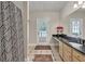 Bathroom with double vanity, granite countertop, and walk-out to patio at 5588 Rhododendron Trl, Douglasville, GA 30135