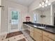 Bathroom with double vanity, granite countertop, and access to the patio at 5588 Rhododendron Trl, Douglasville, GA 30135