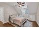 A bedroom with wood floors, neutral walls, recessed lights, ceiling fan, and a window allows natural light at 5588 Rhododendron Trl, Douglasville, GA 30135