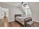 A cozy bedroom with wood floors, neutral walls, recessed lighting, and a window allows plenty of natural light at 5588 Rhododendron Trl, Douglasville, GA 30135
