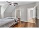 A cozy bedroom with wood floors, neutral walls, recessed lighting, and two windows allows plenty of natural light at 5588 Rhododendron Trl, Douglasville, GA 30135