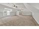 This large bonus room features neutral carpet, recessed lights, and ceiling fans for comfortable temperature control at 5588 Rhododendron Trl, Douglasville, GA 30135