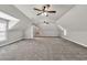Large bonus room with carpeting, ceiling fans, and natural light at 5588 Rhododendron Trl, Douglasville, GA 30135